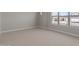 Bright bedroom with neutral carpet, a window view, and white trim at 1021 W Ridge Rd, Apache Junction, AZ 85120