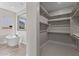 Walk-in closet leading to the primary bath with a soaking tub and a window with natural light at 1021 W Ridge Rd, Apache Junction, AZ 85120
