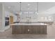 Modern kitchen featuring white cabinets, stainless appliances, a large island, and an elegant backsplash at 1021 W Ridge Rd, Apache Junction, AZ 85120