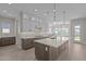 Stylish kitchen with granite countertops, a center island, stainless steel appliances, and gray cabinets at 1021 W Ridge Rd, Apache Junction, AZ 85120