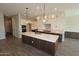 Close-up view of a kitchen featuring a large island and pendant lights at 1021 W Ridge Rd, Apache Junction, AZ 85120