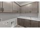 Functional laundry room with abundant cabinet storage and a sink for added convenience at 1021 W Ridge Rd, Apache Junction, AZ 85120