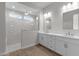 Bathroom featuring double sink vanity, tile floors, and frameless glass walk-in shower at 1042 W Ridge Rd, Apache Junction, AZ 85120