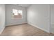 Bright bedroom featuring wood-look floors and a window with backyard views at 1042 W Ridge Rd, Apache Junction, AZ 85120
