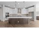 Gourmet kitchen featuring an island, custom cabinets, modern appliances, and pendant lighting at 1042 W Ridge Rd, Apache Junction, AZ 85120