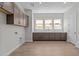 Spacious laundry room with ample counter space, cabinets and tile flooring at 1042 W Ridge Rd, Apache Junction, AZ 85120