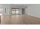 Spacious living room with wood-look tile floors and a large sliding glass door at 1042 W Ridge Rd, Apache Junction, AZ 85120