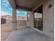 Covered patio with sliding glass door, offering access to backyard at 18336 W Daley Ln, Surprise, AZ 85387