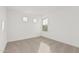 Well-lit bedroom with neutral wall and carpet at 18336 W Daley Ln, Surprise, AZ 85387