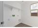 Laundry room with overhead shelving and window at 18336 W Daley Ln, Surprise, AZ 85387