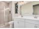 This bathroom offers a double sink, vanity, large mirror, and glass door shower at 18762 E Panchito Dr, Gold Canyon, AZ 85118