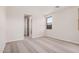 A neutral colored carpeted bedroom with natural lighting and a view to the hallway and a window to the outside at 18762 E Panchito Dr, Gold Canyon, AZ 85118