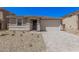 Charming single-story home with a two-car garage, stone accents, and low-maintenance desert landscaping at 18762 E Panchito Dr, Gold Canyon, AZ 85118