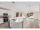 Modern kitchen with stainless appliances, a breakfast bar and an open floorplan flowing into the bright living space at 18762 E Panchito Dr, Gold Canyon, AZ 85118