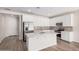 Spacious kitchen with stainless steel appliances, a large center island, and stylish, light-colored backsplash at 18762 E Panchito Dr, Gold Canyon, AZ 85118