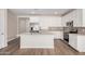 Bright, open kitchen features white cabinets, stainless steel appliances, a gray backsplash, and a center island at 18762 E Panchito Dr, Gold Canyon, AZ 85118