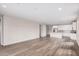 Spacious living room featuring wood-look flooring and plenty of natural light and open floorplan to kitchen at 18762 E Panchito Dr, Gold Canyon, AZ 85118