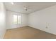 Simple carpeted bedroom with window and ceiling fan at 11067 W Oak Ridge Rd, Sun City, AZ 85351