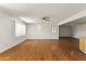 Living room with hardwood floors, ceiling fan, and adjacent dining area at 11067 W Oak Ridge Rd, Sun City, AZ 85351