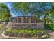 Stone monument sign for Legend Ridge community, lush landscaping, and mature trees in the background at 1695 E Mia Ln, Gilbert, AZ 85298