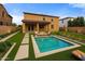 Beautiful backyard featuring a pool, artificial grass, and a cozy fire pit with modern patio furniture at 1695 E Mia Ln, Gilbert, AZ 85298