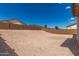 A clear blue sky stretches over a spacious backyard, enclosed with privacy walls for comfort at 18792 E Panchito Dr, Gold Canyon, AZ 85118
