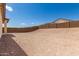 A clear blue sky stretches over a spacious backyard, enclosed with privacy walls for comfort at 18792 E Panchito Dr, Gold Canyon, AZ 85118