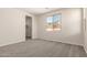 Well-lit bedroom with soft carpet, neutral walls, and a closet with a window at 18792 E Panchito Dr, Gold Canyon, AZ 85118