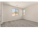 Bright bedroom with neutral walls, plush carpet, and natural light from two windows at 18792 E Panchito Dr, Gold Canyon, AZ 85118