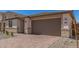 The house has a two-car garage and the exterior is adorned with stone veneer accents at 18792 E Panchito Dr, Gold Canyon, AZ 85118