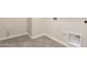 This practical laundry room has neutral tile floors and essential hookups for laundry appliances at 18792 E Panchito Dr, Gold Canyon, AZ 85118