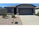 Charming single-story home with a two-car garage and low-maintenance desert landscaping at 38155 W Excussare Way, Maricopa, AZ 85138