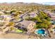 Aerial view of house, pool, and putting green, with mountain views in the background at 6907 E Teton Cir, Mesa, AZ 85207