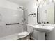 Clean bathroom with shower, toilet, and pedestal sink at 4232 W Nicolet Ave, Phoenix, AZ 85051