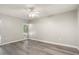 Bright bedroom with ceiling fan and large window letting in natural light at 11133 W Cameo Dr, Sun City, AZ 85351