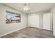 Neutral bedroom featuring wood-look floors, a ceiling fan, and a closet with bi-fold doors at 11133 W Cameo Dr, Sun City, AZ 85351