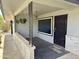 Welcoming covered front porch with decorative metal accents and neutral tones at 11133 W Cameo Dr, Sun City, AZ 85351