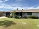 Inviting single-story home with lush green lawn and manicured front yard landscaping at 11133 W Cameo Dr, Sun City, AZ 85351