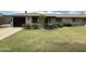 Charming single-story home with a well-manicured lawn and mature landscaping at 11133 W Cameo Dr, Sun City, AZ 85351