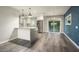 Modern kitchen with stainless steel appliances and a breakfast bar with views into an outdoor patio space at 11133 W Cameo Dr, Sun City, AZ 85351