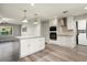 Open-concept kitchen featuring white cabinetry, stainless steel appliances and pendant lighting at 11133 W Cameo Dr, Sun City, AZ 85351