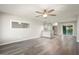 Bright living room featuring ceiling fan and open kitchen concept at 11133 W Cameo Dr, Sun City, AZ 85351