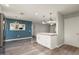 Cozy living room featuring ceiling fan and open kitchen concept at 11133 W Cameo Dr, Sun City, AZ 85351