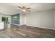 Open-concept living room with ceiling fan and modern flooring at 11133 W Cameo Dr, Sun City, AZ 85351