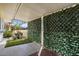 Covered patio space featuring lush privacy screening and views of the outdoor landscape at 11133 W Cameo Dr, Sun City, AZ 85351