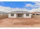 Spacious backyard featuring a covered patio and new home construction at 18798 E Elizar Dr, Gold Canyon, AZ 85118