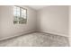 This carpeted bedroom with neutral walls features a large window looking out onto the neighborhood at 18798 E Elizar Dr, Gold Canyon, AZ 85118