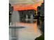 Serene water view with fountains reflecting a vibrant sunset sky at 2511 W Queen Creek Rd # 205, Chandler, AZ 85248
