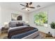 Comfortable bedroom with a large window, soft lighting, and neutral decor at 4548 E Carob Dr, Gilbert, AZ 85298