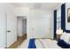 Clean bedroom with a sliding door closet, natural light and adjacent room at 4548 E Carob Dr, Gilbert, AZ 85298